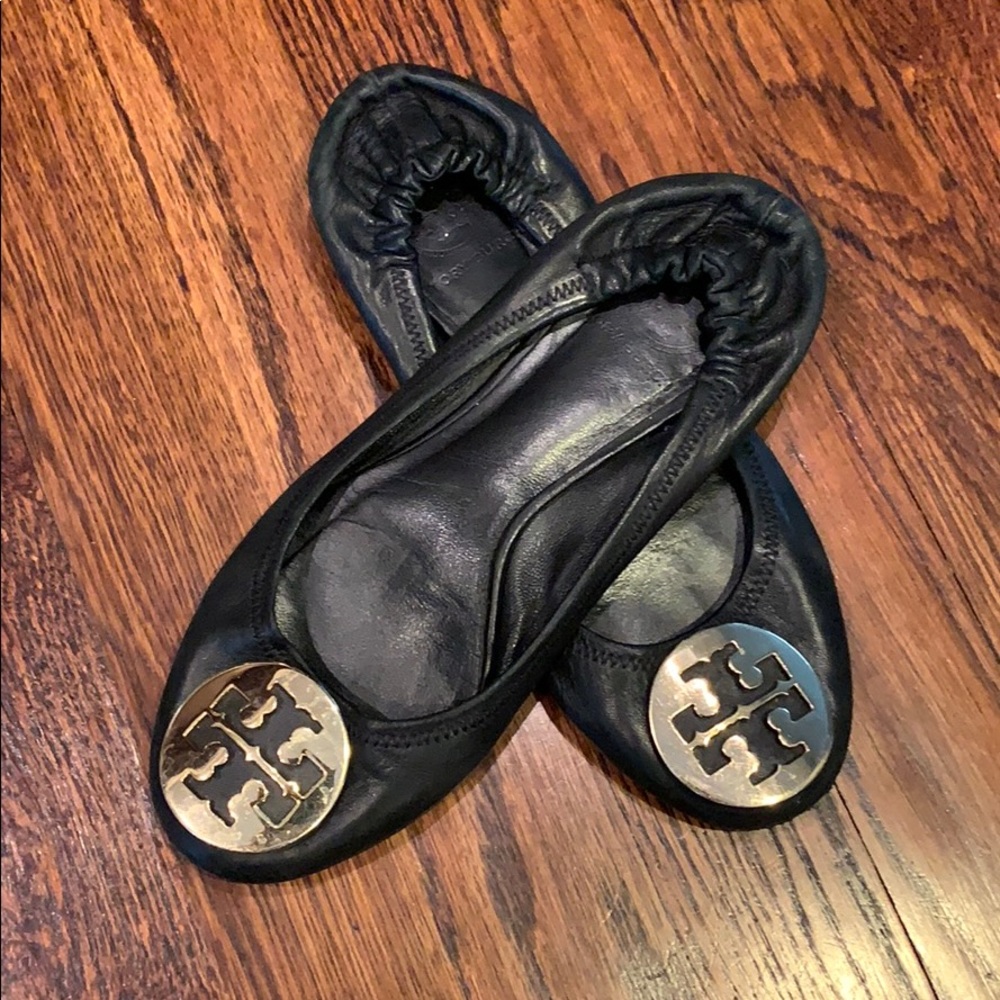 Black Tory Burch flats with gold logo medallion